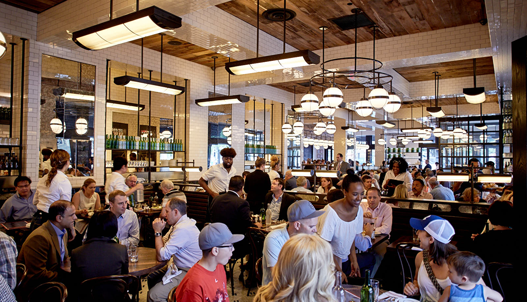 A photo of the main dining room at The Smith Penn Quarter filled with guests